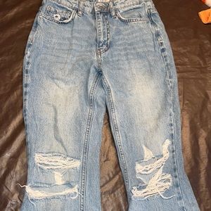 Light wash jeans with holes and flare at the end